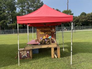 Gem mining attraction under a red popup tent.